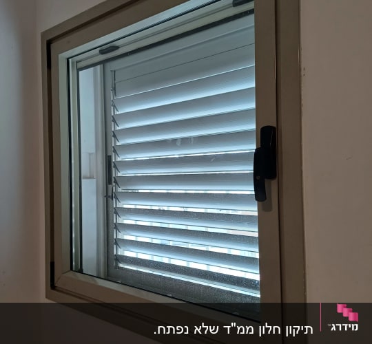 תריסים אופקיים בתוך מסגרת חלון מתכתית